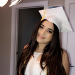 A person in white wearing a graduation cap